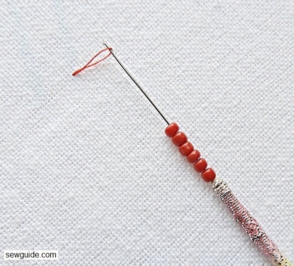 take up the loop of thread with the ari needle