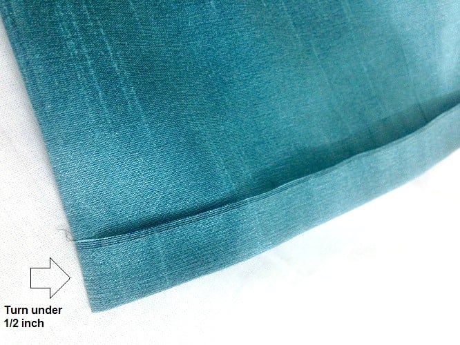 Turn under the fabric 1/2 inch to stitch the blind hem stitch