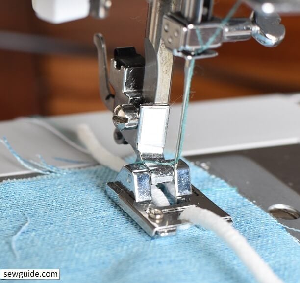 Insert cord through the hole on the braiding foot