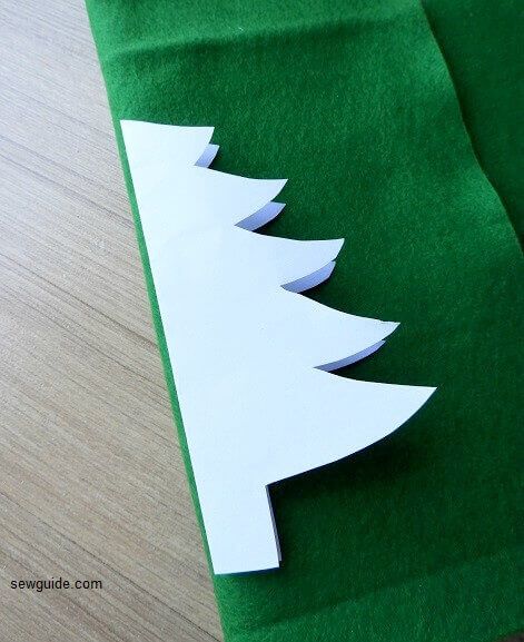 mark the christmas tree on folded felt fabric for making the christmas ornament