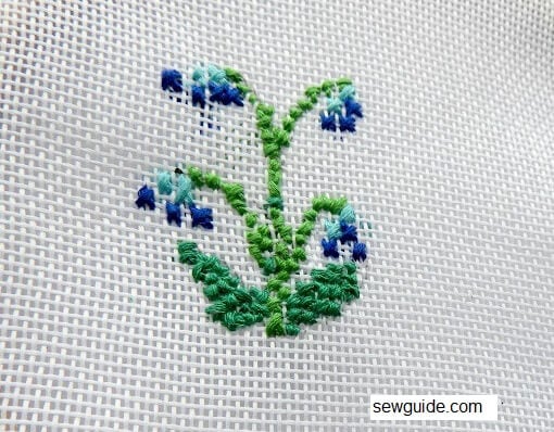 blue color flowers with cross stitch