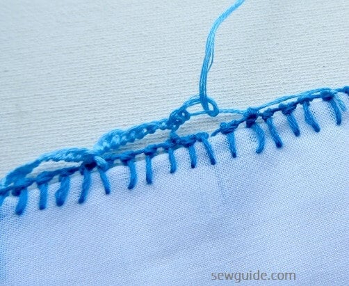 continue making loops or blanket stitches along the thread loops