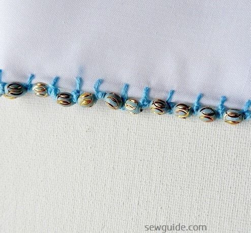 embroidery edge stitches with beads along edges of scarves or necklines