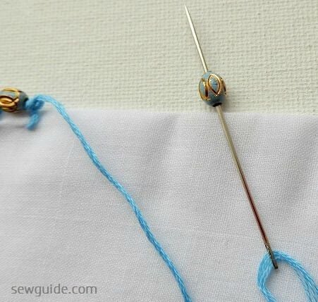 sew beaded embroidery edge stitches- thread the needle with the bead in between