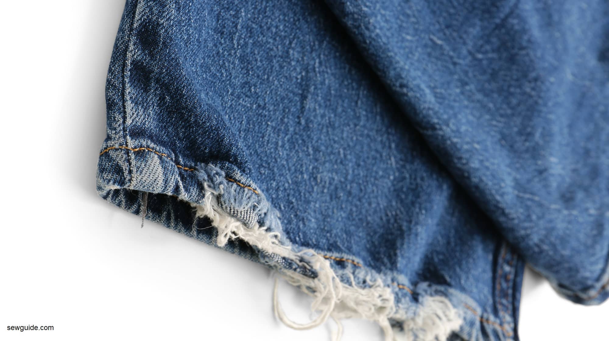 A blue jeans hem which is frayed