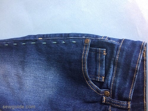 Running stitches made on the outer seam of jeans