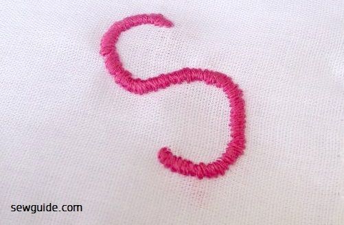 embroidered letter with satin stitch.