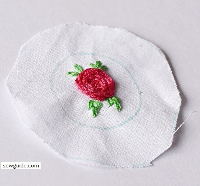 small woven rose embroidered with leaves
