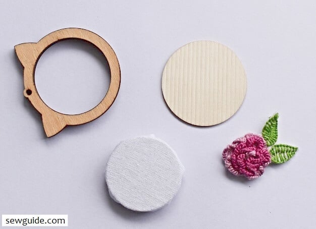 Cut out the cast on stitch rose and attach to the base