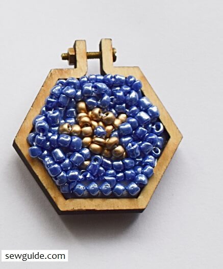 bead embroidery fill the insides of the pendant fabric