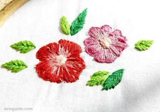long and short stitches fill the design; the leaves are filled with close fly stitches