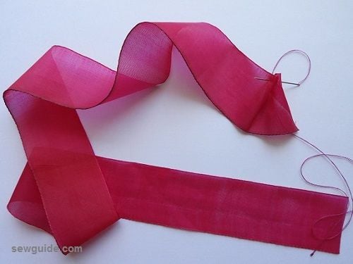 fold and stitch one end of the ribbon