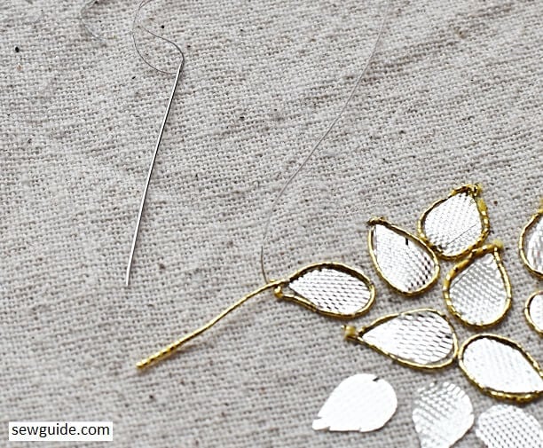 couching stitch used to attach metallic thread around gotta patti work