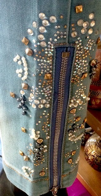 jeans embellished with rhinestones along the hem