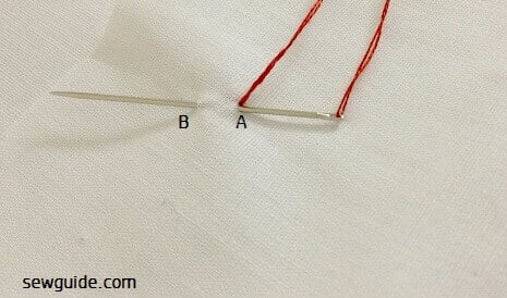 Make a stitch very clse to where you inserted the needle