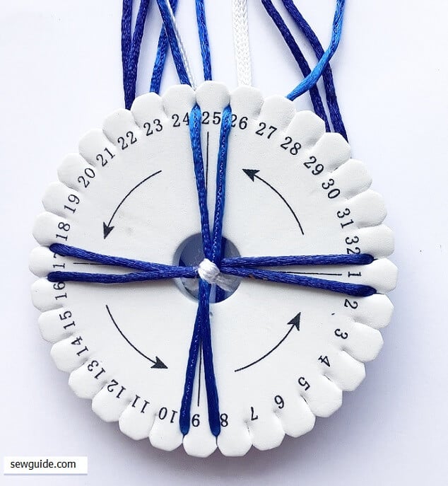 insert two cord each through the grooves in the disc