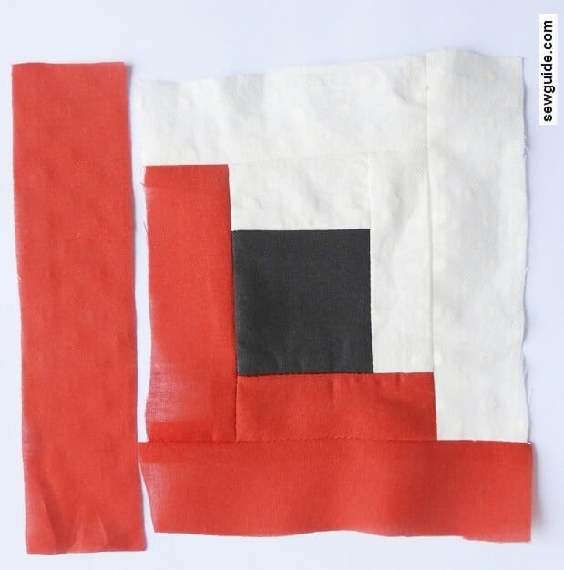 one side of fabric sewn to log cabin block