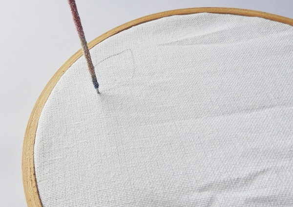 insert the needle into the fabric