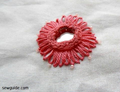 Lazy daisy stitch sorrounds the mirror