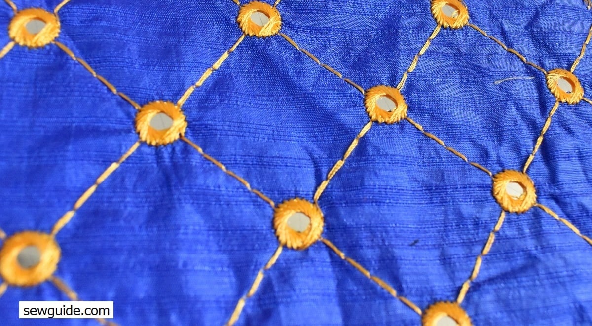 mirror work combined with embroidery to make all over pattern on fabric