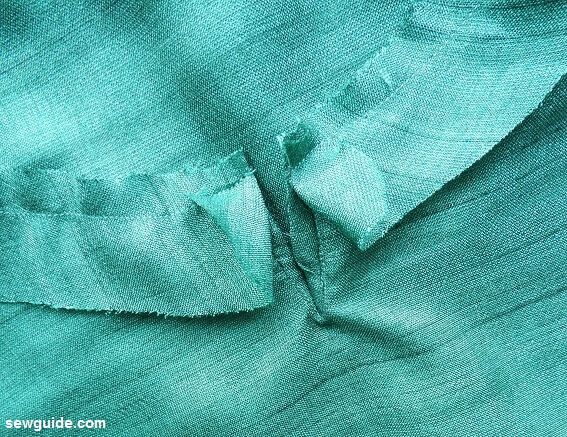 keep binding on top of neckline after folding the edges to the inside