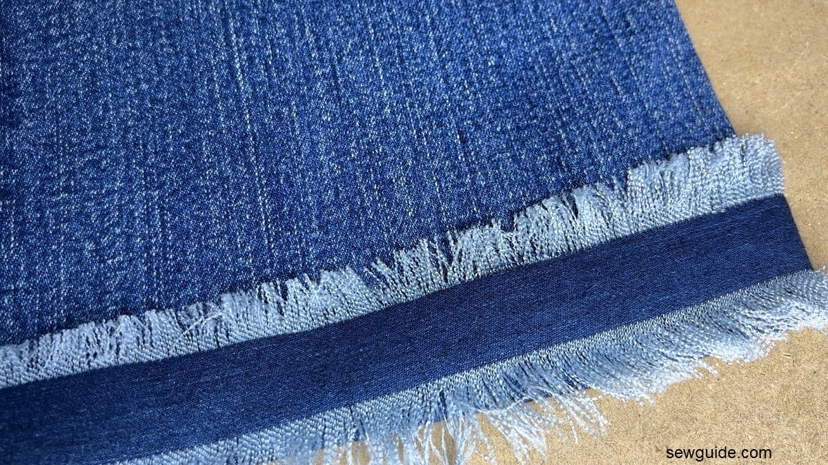 frayed edge denim piece attached to jeans hem