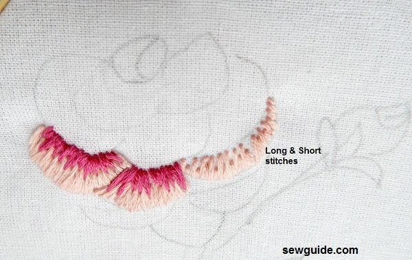 Long and short stitches worked with light and dark colored embroidery floss