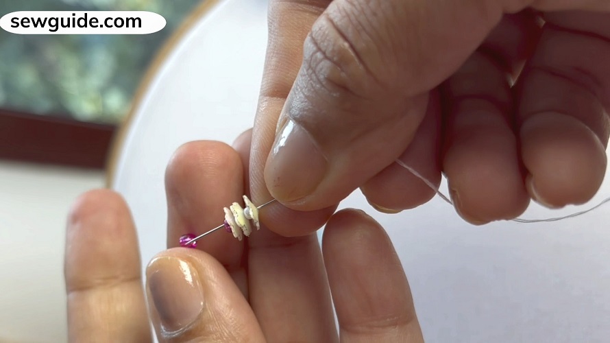 thread needle with lots of sequins and seed beads