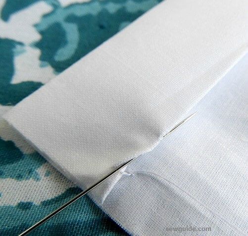 insert the needle through the fold of the fabric to make the split invisible stitch