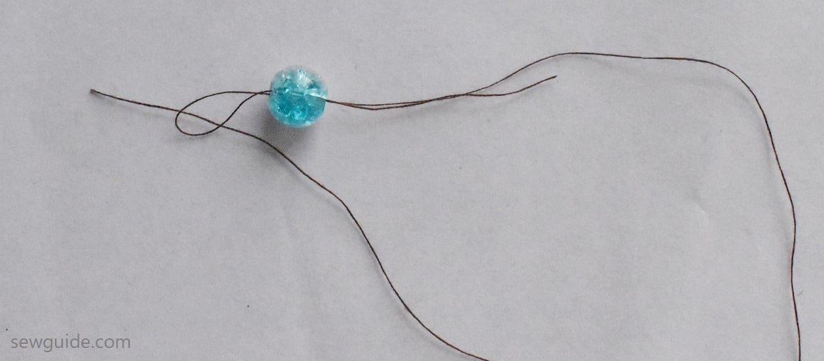 bring the other side of the thread through the loop