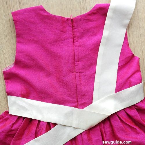 tying a sash bow in a dress