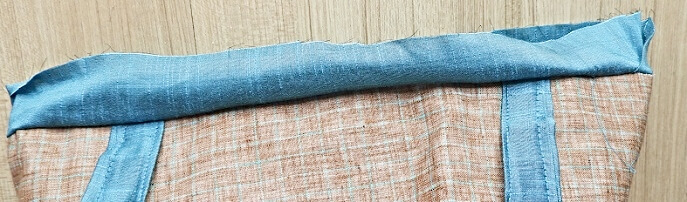 press the binding to the inside and sew