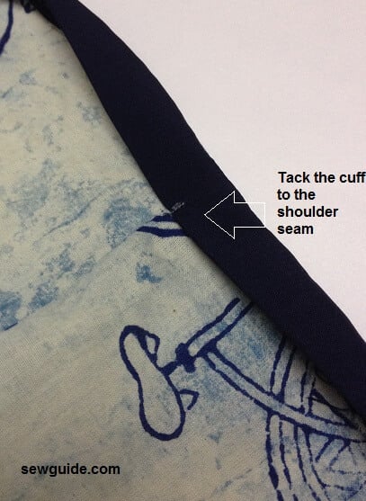 bring the binding to the front of the tunic sleeves