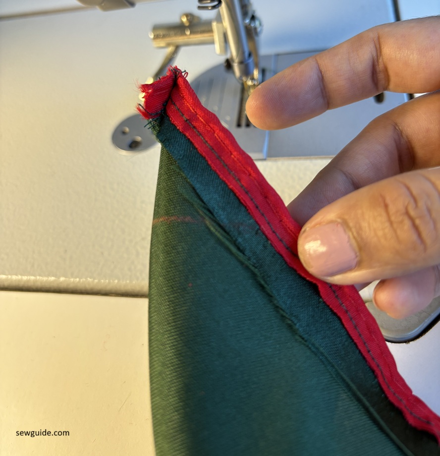 fold the corner right sides to the inside to sew the mitered corner on the napkin